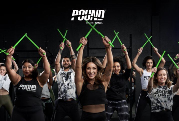 POUND class: group raising Ripstix drumsticks overhead