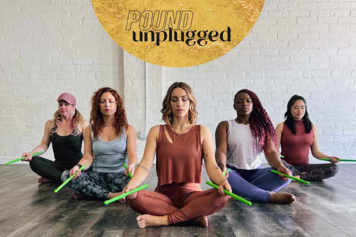 POUND Unplugged class: seated meditation holding Ripstix